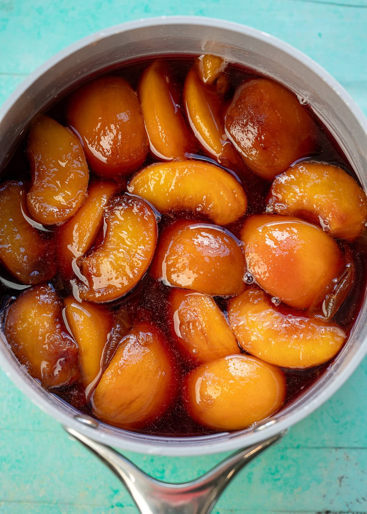 peach simple syrup in a pot