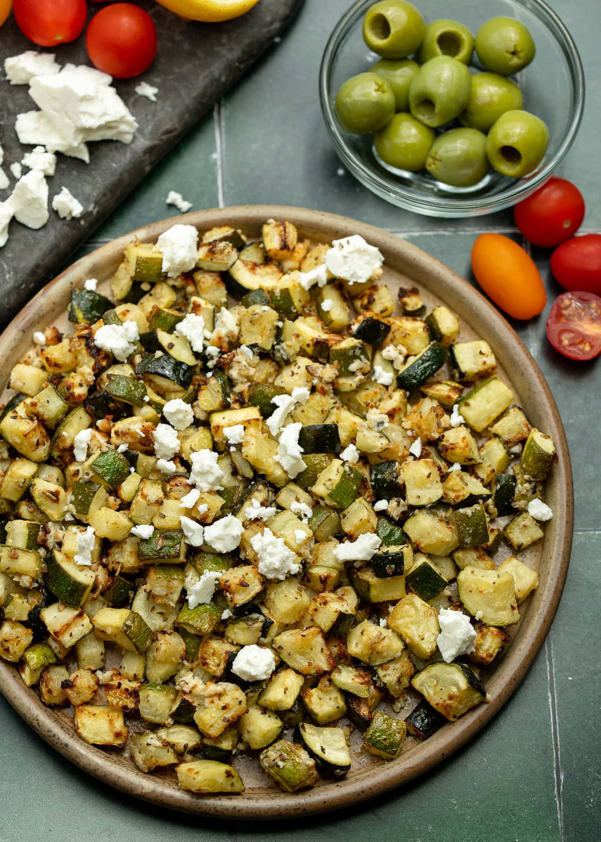 an overhead shot of zucchini cooked in the air fryer and garnished with feta