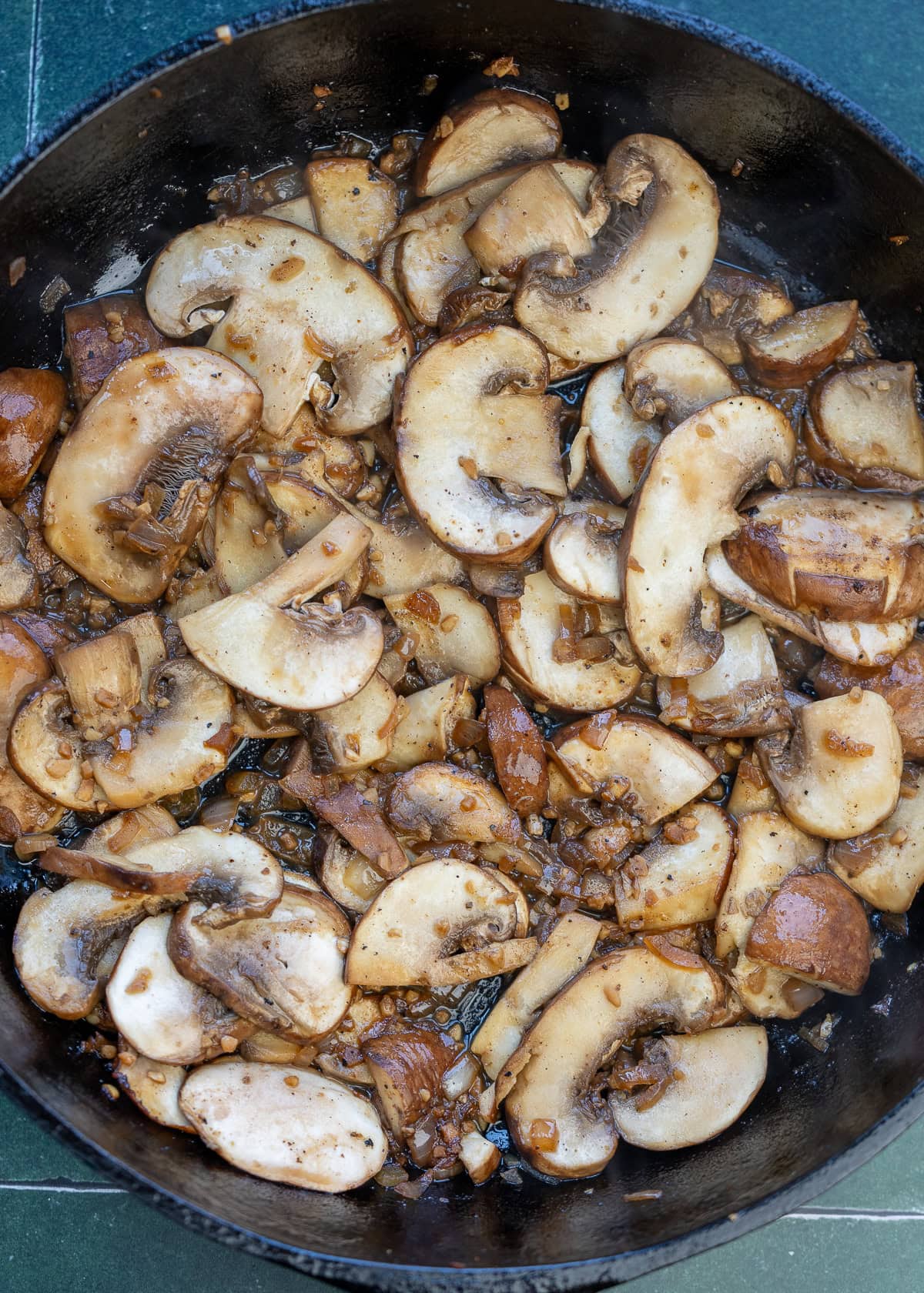 cooked mushrooms reducing in a pan