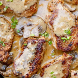 creamy mushroom gravy over juicy pork medallions in a cast iron skillet
