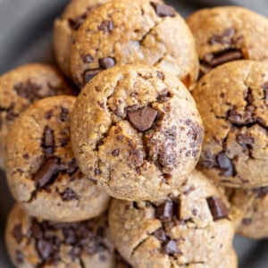 overhead shot showing a stack of banana oat muffins on a plate
