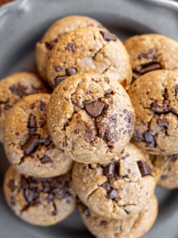 overhead shot showing a stack of banana oat muffins on a plate