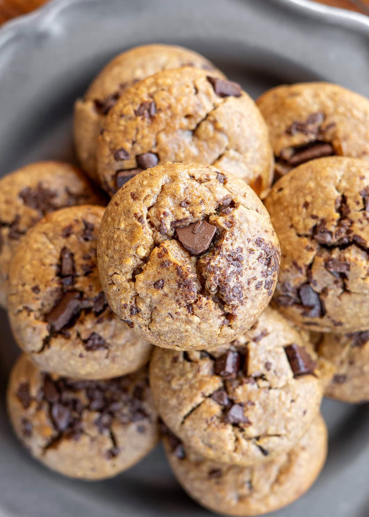 overhead shot showing a stack of banana oat muffins on a plate