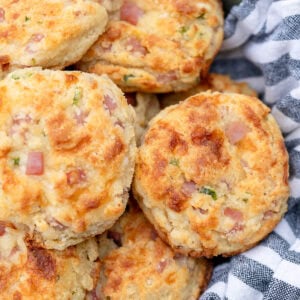 a basket full of cheesy gluten free muffins filled with cottage cheese, jam, and jalapeno