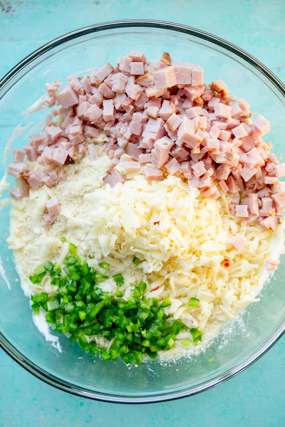 almond flour, ham, cheese, jalapeno, in a glass bowl with whipped cottage cheese and egg