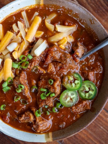 overhead shot of chuck roast chili con carne with toppings